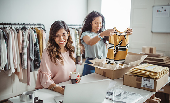 Two women working in their clothing retail business